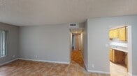This 700 square foot apartment offers a practical and efficient living space. The single-story layout comprises two bedrooms, one bathroom, a living room, kitchen, hallway, and closet. The primary bedroom, measuring 150 square feet, provides a comfortable retreat.

Throughout the apartment, terracotta-colored tile flooring creates a cohesive look and easy-to-maintain surface. The galley kitchen features wooden cabinetry and granite countertops, offering ample storage and food preparation areas. Stainless steel appliances complement the modern aesthetic.

The living room boasts a large window, flooding the space with natural light and providing views of the surrounding greenery. A striking blue accent wall adds visual interest to this area. Both bedrooms are well-proportioned, with one room featuring a window that allows for additional natural light.

The bathroom, while compact, includes essential fixtures such as a toilet, bathtub, and shower. The hallway provides access to all rooms and includes a closet for additional storage. Overall, the apartment's neutral color palette, combined with its practical layout, creates a versatile living space suitable for various lifestyle needs.