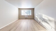This newly renovated 780 square foot apartment offers a harmonious blend of comfort and functionality. The space comprises three bedrooms, including a primary bedroom of 140 square feet, one bathroom, and an open-concept kitchen and living room area. The interior is characterized by a neutral color palette, with light beige walls and modern light wood-look flooring throughout, creating a bright and airy atmosphere.

The kitchen is a standout feature, boasting crisp white cabinetry, granite countertops, and stainless steel appliances. It's equipped with ample storage and counter space, making it both practical and visually appealing. The living area is spacious and well-lit, with large windows that allow natural light to flood the room, creating a warm and inviting ambiance.

Each bedroom is generously sized, with the primary bedroom offering 140 square feet of space. The rooms feature baseboard heating and windows that provide natural light and ventilation. The bathroom, while compact, is efficiently designed with a modern white vanity and fixtures.

Storage solutions are integrated throughout the apartment, including a walk-in closet with built-in shelving. The property also includes modern amenities such as an in-unit air conditioning system. Located at 1225 Doctors, 106, this single-story apartment combines contemporary design with practical living, making it an ideal choice for small families or professionals seeking a comfortable urban dwelling.