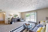Located at 11305 Pratt St in Omaha, Nebraska, this one-bedroom, one-bathroom unit offers a well-organized single-floor layout encompassing a comfortable and functional living space. The living room is a standout feature, highlighted by a textured ceiling, plush carpeting, and a sliding glass door that opens to a private balcony with outdoor views — allowing natural light to fill the room. The open flow connects the living area to a dedicated dining room, complete with a ceiling fan and carpet flooring, ideal for everyday meals. The galley-style kitchen features warm wood cabinetry, light countertops, black appliances including a range and refrigerator, and durable hardwood-style flooring. The spacious bedroom offers two closets, a textured ceiling, carpet flooring, and a window providing natural light. A hallway connects the rooms efficiently, with decorative touches adding character to the transition spaces. The full bathroom includes a vanity with dark wood cabinetry, a tub and shower combination with a glass door, tile wainscoting, and hardwood-style flooring. Throughout the unit, neutral tones and consistent finishes create a cohesive and inviting atmosphere well-suited for comfortable everyday living in Omaha.