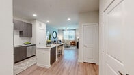 Located at 5901 County Road 277 in Melissa, TX, this 1-bedroom, 1-bathroom residence offers a thoughtfully designed open-concept layout that maximizes every inch of its single-floor footprint. Light wood-style flooring flows consistently throughout, tying together each area seamlessly.

The combined kitchen and living room serves as the heart of the home. The kitchen features dark espresso cabinetry extending to the ceiling, light granite countertops, stainless steel appliances including a refrigerator, range, and microwave, and a peninsula with bar seating — ideal for casual dining or entertaining. Recessed lighting brightens the space, while the open sightline connects effortlessly to the living area.

The living room is bathed in natural light from large windows dressed with blinds and sheer curtains. A ceiling fan overhead adds comfort, and the soft, neutral color palette with light blue accent walls creates a calm and inviting atmosphere.

The bedroom is a comfortable retreat, highlighted by a striking teal accent wall, a ceiling fan, and large windows with patio door access that flood the room with natural light. It includes direct access to the bathroom and a dedicated closet.

The bathroom features dark cabinetry with granite countertops, a large mirror, and wood-style flooring, maintaining the cohesive, modern aesthetic found throughout the entire residence.