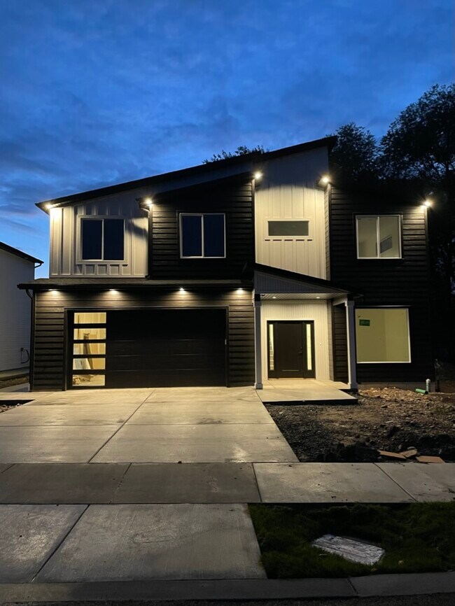 Front of home at night w/ exterior lighting - 867 W Three Pt Ave