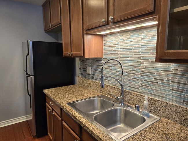 Kitchen (sink area with overhead lighting) - 9939 Azuaga St