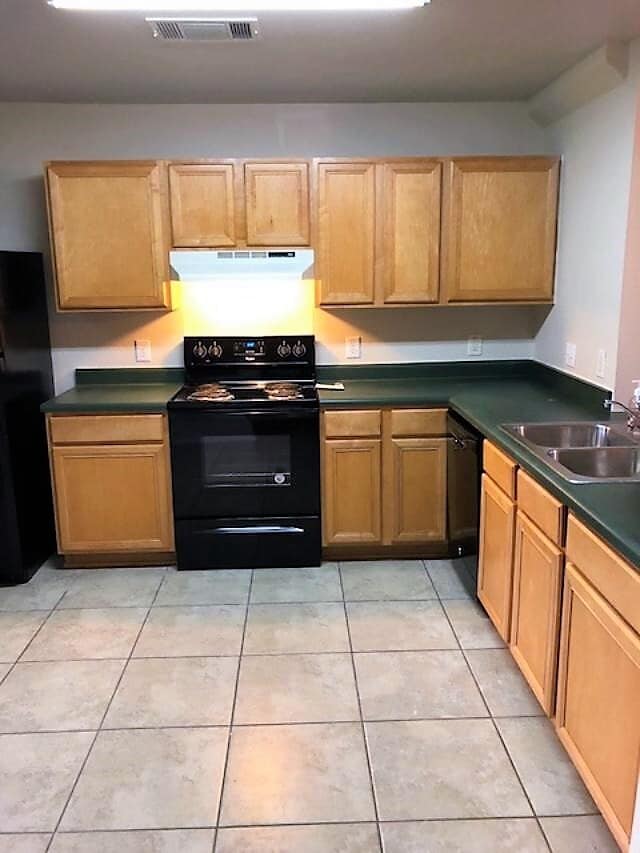 modern kitchen with black electric stove, dishwasher and refrigerator - 10617 Garbacz Dr