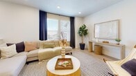 Located in Saratoga Springs, Utah, this two-bedroom, two-bathroom home spans two floors with a thoughtfully designed layout. The main level houses an open-concept kitchen and living area, where light wood-tone cabinetry, stainless steel appliances — including a French door refrigerator, electric range, and over-the-range microwave — and clean white countertops create a modern, functional kitchen. A dining area sits adjacent, offering a natural gathering space. The living room features recessed lighting, light hardwood-style flooring, and large windows that invite natural light throughout.

The upper level hosts both bedrooms, each finished with plush carpeting and recessed lighting. The spacious primary bedroom offers room for a full furniture suite, while the second bedroom includes a closet and access to a hallway bathroom. Both bathrooms are finished with warm wood-grain floating vanities, white countertops, and light hardwood-style flooring — one featuring a walk-in shower aesthetic and the other a full tub/shower combo. A staircase connects the two levels, and a hallway and closet round out the home's practical layout. The overall aesthetic is clean, contemporary, and warm throughout.