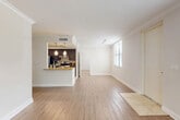 Located in Miami Lakes, FL, this well-appointed 2-bedroom, 3-bathroom single-floor residence offers a thoughtfully designed layout with comfortable living spaces throughout. The open-concept living and dining area is bright and airy, featuring light wood-style flooring, crown molding, and large windows with blinds that invite abundant natural light. The kitchen is a standout feature, offering dark espresso cabinetry, granite countertops, a mosaic tile backsplash, stainless steel appliances including a refrigerator, range, and dishwasher, and pendant lighting above a peninsula that connects seamlessly to the living area. Both bedrooms are carpeted and equipped with ceiling fans, and each benefits from natural light through windowed walls. The generously sized primary bedroom includes access to a walk-in closet with extensive wire shelving. The bathrooms are finished with granite-topped dark vanities and tile flooring, reflecting the same quality found throughout the home. A dedicated laundry area houses a full-size washer and dryer. A hallway connects the living spaces to the private quarters, completing a functional and cohesive floor plan suited for everyday comfort.