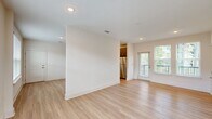 Located at 12801 Lucks Lane in Midlothian, VA, this thoughtfully designed one-bedroom, one-bathroom unit offers a clean, contemporary aesthetic across a well-utilized single floor. Light-toned hardwood-style flooring flows throughout the open living areas, creating a bright and cohesive feel. The layout includes two distinct living spaces, providing flexibility for both lounging and dining or home office use. Large windows invite generous natural light and offer views of the surrounding community.

The kitchen is appointed with sleek gray cabinetry, granite countertops, a white tile backsplash, and a full suite of stainless steel appliances, including a range, over-the-range microwave, and dishwasher. A window above the sink adds natural light to the workspace.

The bedroom features plush carpeting, a ceiling fan, multiple windows with exterior views, and direct access to a dedicated closet. The bathroom is finished with a gray vanity, granite countertop, a tub-shower combination, and wood-look tile flooring, maintaining the modern palette found throughout.

A dedicated laundry area houses a full-size side-by-side washer and dryer with overhead wire shelving for added storage. Recessed lighting, clean white walls, and consistent finishes throughout give this unit a polished, move-in-ready appearance.