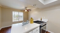 Located at 861 Glencliff St in La Habra, California, this single-story 2-bedroom, 1-bathroom home offers a well-organized layout across a comfortable footprint. The living room welcomes you with rich, dark hardwood flooring, elegant crown molding, and a large window fitted with vertical blinds that fills the space with natural light. The open connection to the kitchen makes the common areas feel cohesive and practical.

The kitchen is a standout feature, boasting white shaker-style cabinetry, a mosaic tile backsplash, and crisp white countertops. Stainless steel appliances — including a gas range, dishwasher, and refrigerator — add a modern touch, while a tray ceiling with a skylight overhead brings in additional natural light. A peninsula provides extra prep and dining space, with views into the adjacent living and dining areas.

Both bedrooms are carpeted in warm neutral tones and feature vertical blinds that allow for natural light and privacy. The primary bedroom offers a generous amount of space. The bathroom is clean and functional, featuring a full soaking tub with a bright white surround. A hallway and closet round out the floor plan, ensuring practical storage throughout. The home's warm beige palette and consistent finishes create a cohesive, comfortable atmosphere.