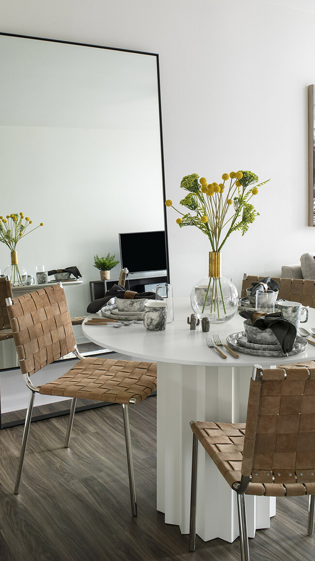 Apartment dining room with wood-style flooring. - Griffis Cherry Creek