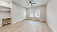 Located at 600 E Panther Way in Hewitt, TX, this single-story, 2-bedroom, 2-bathroom home offers a thoughtfully designed open-concept layout with modern finishes throughout. Light-toned luxury vinyl plank flooring flows seamlessly through every room, creating a cohesive and clean aesthetic.

The kitchen is a standout feature, showcasing white shaker-style cabinetry, a classic subway tile backsplash, a central island with a built-in sink and pendant lighting, and a full suite of stainless steel appliances including a French door refrigerator, range, and microwave. The adjoining living area is bright and airy, benefiting from natural light through windows with blinds, a ceiling fan, and a built-in shelving nook with a small desk area.

The primary bedroom is generously sized, offering recessed lighting, ceiling fan, and multiple closet access points. The second bedroom features a double-door closet, a ceiling fan, and a window with views of the surrounding area. Both rooms are finished in warm neutral tones.

The two bathrooms are distinctly styled. One features a marble-tile tub/shower surround with a gray vanity, while the other offers a dramatic dark marble-tile walk-in shower with a glass sliding door. Both bathrooms include contemporary fixtures and finishes, delivering a refined, spa-like experience.