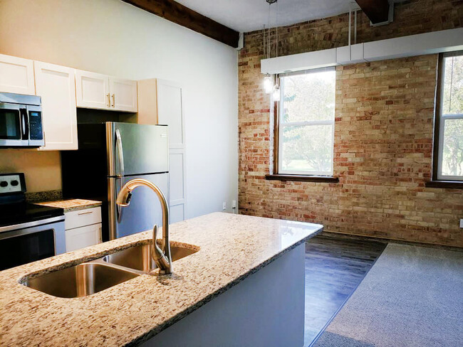 Exposed Brick Walls at Riverwalk - Grand Ledge Apartments