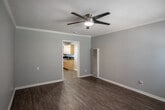 Located at 901 S Harbor Blvd in Santa Ana, California, this single-floor unit offers a practical and well-maintained living layout. The living area is spacious and open, featuring durable wood-look plank flooring, crown molding, and a modern ceiling fan with integrated lighting. Neutral gray walls create a clean, versatile backdrop throughout the space. A wall-mounted HVAC unit and a front entry door with a transom window provide comfort and natural light, while window blinds offer added privacy.

The kitchen is efficiently designed with warm-toned light wood cabinetry, dark granite-style countertops, a double-basin sink, a gas range, and a built-in microwave. A window above the sink brings in natural light, and recessed ceiling lighting adds functionality to the workspace.

The bathroom is clean and straightforward, featuring a wood-toned vanity with a dark countertop, a toilet, and a full tub-shower combination enclosed in a white surround. A high transom window allows light into the space while maintaining privacy.

Throughout the unit, consistent wood-look flooring ties the rooms together, and the overall design emphasizes practicality and ease of maintenance. This unit is well-suited for those seeking a functional, move-in-ready space in the Santa Ana area.