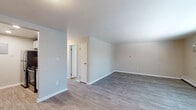 Located at 5100 Leetsdale Drive in Denver, Colorado, this single-floor unit offers a well-organized layout with a clean, updated aesthetic throughout. The open living area features durable wood-style plank flooring, soft neutral-toned walls, and crisp white baseboards, creating a bright and welcoming atmosphere. A wall-mounted air conditioning unit and baseboard heating provide year-round climate control, while a window with blinds allows natural light to fill the space.

The galley-style kitchen is thoughtfully appointed with white shaker cabinetry, granite-look countertops, a stainless steel sink, and stainless steel appliances including a refrigerator, microwave, and electric range. Light wood-style flooring continues through the kitchen, complementing the contemporary finishes.

The bedroom is carpeted for added comfort and features a window overlooking the surrounding neighborhood, along with baseboard heating. The full bathroom includes a tub-shower combination, toilet, and a towel bar, finished with neutral tones and wood-style flooring. Additional interior doors provide access to closet and utility areas. The overall design emphasizes functionality and modern simplicity, making this a practical and move-in-ready space in a convenient Denver location.