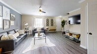 Located at 110 International Dr, Unit 27, in Athens, GA, this two-story residence offers 1,270 square feet of living space with 4 bedrooms, 4 bathrooms, and a well-designed layout spread evenly across two floors of approximately 640 and 630 square feet each. The main level features a living room finished with hardwood-style flooring, crown molding, a textured ceiling, and a ceiling fan, creating a comfortable and inviting common area. Adjacent to the living room, the galley-style kitchen is equipped with light wood cabinetry, dark granite-style countertops, a stainless steel refrigerator, and a range, with hardwood-style flooring continuing throughout. The main level also includes a convenient laundry area housing a full-size washer and dryer. A bright entryway with a windowed front door brings in natural light. Each of the four bedrooms features plush carpeting and windows, with the primary bedroom measuring 160 square feet and offering a sliding-door closet. The four bathrooms are consistently appointed with wood-toned vanity cabinetry, white countertops, and shower-tub combinations. Two staircases connect the floors, adding accessibility throughout. In-unit laundry hookups are present on both levels.