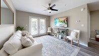 Located at 342 Riverwood Dr in Crestview, FL, this well-appointed 2-bedroom, 2-bathroom single-story home offers a thoughtfully designed layout that maximizes functionality and comfort. The open-concept living and kitchen area serves as the heart of the home, with the living room featuring warm neutral tones, a ceiling fan with light, soft carpeted area rug, and bright French doors that invite natural light and provide outdoor access. The kitchen is finished with sleek gray shaker cabinetry, white quartz countertops, a subway tile backsplash, stainless steel appliances including a range, microwave, and refrigerator, and durable wood-look plank flooring throughout. Both bedrooms are carpeted and offer ceiling fans, natural light through window treatments, and generous closet space — the home features an impressive six closets in total. The bathrooms are finished consistently with the kitchen, showcasing matching gray vanity cabinetry, white countertops, and a tub/shower combination. A dedicated in-unit laundry area with overhead shelving adds everyday convenience. With a cohesive neutral palette and modern finishes throughout, this home delivers a clean, inviting ambiance ideal for comfortable living.