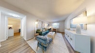 Located on Sutton Circle in Daytona Beach, Florida, this well-appointed two-bedroom, one-bathroom residence offers a thoughtfully designed single-level layout. The open-concept living and dining area is bright and welcoming, featuring wood-look flooring throughout, textured ceilings, and large windows that invite natural light. The living room provides generous space for seating and includes a view through to the dining area, which features a sliding glass door for outdoor access.

The galley-style kitchen is efficiently designed with white shaker cabinetry, white subway tile backsplash, quartz countertops, and stainless steel appliances, including a range, microwave, and dishwasher. A window above the sink adds natural light to the workspace.

The primary bedroom is a comfortable retreat, featuring a ceiling fan, wood-look flooring, and windows with sheer curtains. The second bedroom offers flexibility as a guest room or home office, also with natural light and wood-look flooring. Both rooms share access to a clean, full bathroom with a white-tiled tub-shower combination.

A dedicated closet provides convenient storage, and the neutral color palette throughout creates a cohesive, move-in-ready atmosphere suited to a variety of design preferences.