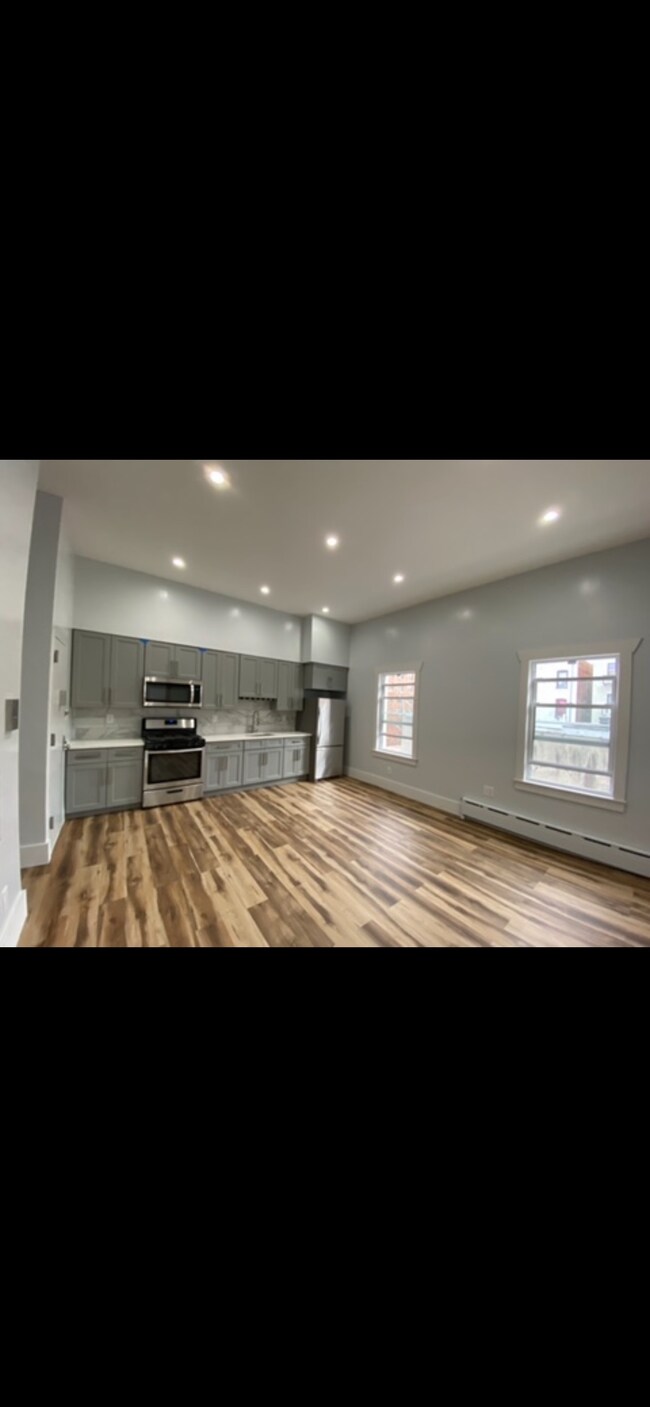 White Quartz countertop, Italian tiles at backsplash. Stainless steel appliances. - 1202 Rogers Ave