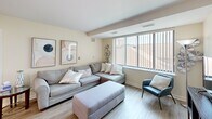 Located at 15101 Ford Rd in Dearborn, Michigan, this single-floor residence offers three bedrooms, one bathroom, and a thoughtfully organized layout designed for comfortable everyday living. Light neutral walls and hardwood-style flooring carry throughout the space, lending a clean, cohesive aesthetic from room to room.

The kitchen features warm honey-toned wood cabinetry with ample upper and lower storage, light countertops, recessed lighting, and white appliances including a refrigerator, range, and built-in microwave. It opens to the combined living area, which benefits from a large window that invites natural light and provides an open, airy feel.

The living room provides a relaxed gathering space with a generously sized window dressed with vertical blinds, allowing for adjustable light and privacy. The primary bedroom is spacious and bright, featuring large windows, light-toned walls, and dual closets offering substantial storage. The additional bedrooms are well-proportioned, each with windows that bring in natural light. The full bathroom includes a single vanity with wood cabinetry, a wall mirror with overhead lighting, and a tub-shower combination. One closet rounds out the layout, providing additional dedicated storage for the household.