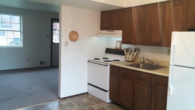 Kitchens come equipped with stove and refrigerator. - Parkridge Apartments