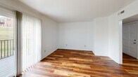 Located on Stratford Park Drive SW in Roanoke, Virginia, this single-floor home offers three bedrooms and three full bathrooms within a well-organized layout. Rich, warm-toned hardwood flooring flows consistently throughout the living areas and all three bedrooms, providing a cohesive and inviting aesthetic across the home.

The living room is bright and open, featuring natural light from sliding glass doors that lead to a private balcony overlooking a grassy yard and neighboring brick building. The dining room is a dedicated space accented by a multi-bulb chandelier with a brushed nickel finish and classic chair-rail molding along the walls, adding a touch of architectural detail.

The kitchen is outfitted with oak cabinetry, dark laminate countertops, tile flooring, and white appliances including a range, dishwasher, and refrigerator. A louvered door off the kitchen reveals a convenient in-unit laundry area with a stacked washer and dryer.

Each bedroom features clean white walls, hardwood floors, and ample natural light. The primary bedroom provides a comfortable amount of space for furnishings. The bathrooms include a tub-shower combination with sliding glass doors and classic tile surrounds. A connecting hallway ties all rooms together efficiently, making this a practical and comfortable home.