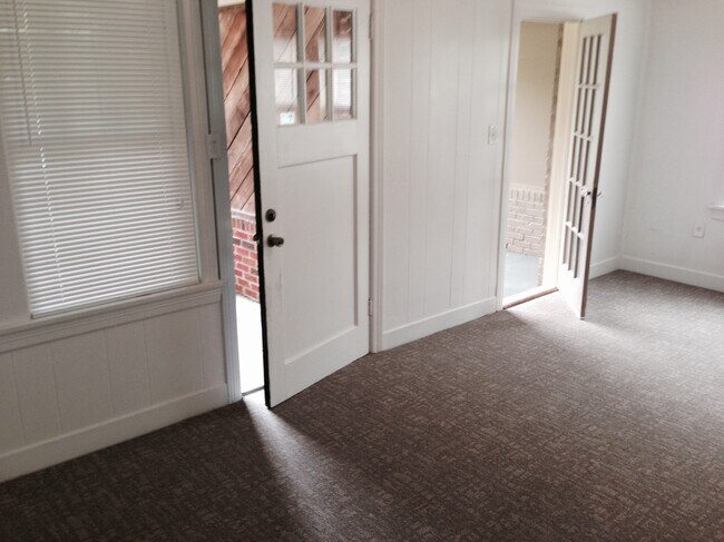 Living room view of front door and sunporch/office to the right. - 4104 Dover St