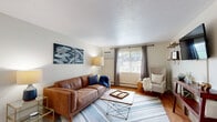 This single-floor, 2-bedroom, 1-bathroom residence in Haverhill, Massachusetts offers a thoughtfully organized layout that makes efficient use of its space. The living room features warm hardwood flooring, neutral-toned walls, a wall-mounted air conditioning unit, and a large window that invites natural light and outdoor views, creating a bright and welcoming atmosphere.

The kitchen is equipped with light wood cabinetry, dark appliances including a full-size refrigerator and dishwasher, and durable countertops. The hardwood flooring continues here, and a dedicated dining nook provides a convenient space for casual meals.

Both bedrooms are carpeted and comfortably sized, offering a quiet retreat. The primary bedroom features multiple windows with views of the outdoors, providing ample natural light. The second bedroom, though more compact, connects easily to the rest of the unit via a hallway. Each room benefits from a neutral color palette that enhances the sense of openness.

The bathroom is finished with clean white tile, a shower-tub combination, and a classic striped curtain, offering a simple and functional design. A connecting hallway ties all rooms together for a cohesive flow throughout the home. This residence is an ideal option for those seeking practical, comfortable living in a residential Haverhill neighborhood.