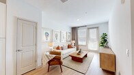 Located at 2420 Medicine Lake Dr in Apopka, Florida, this thoughtfully designed one-bedroom, one-bathroom residence offers a clean, contemporary aesthetic throughout its efficiently arranged single-floor layout. Light wood-tone flooring flows seamlessly across the open-concept living and kitchen areas, creating a cohesive and airy feel.

The kitchen is a standout feature, outfitted with crisp white cabinetry extending to the ceiling, a white tile backsplash, stainless steel appliances including a refrigerator, range, microwave, and dishwasher, and a central island with bar seating — ideal for both meal prep and casual dining.

The living room is bright and welcoming, with large windows that invite natural light and offer outdoor views. The space is anchored by neutral tones and warm accent pieces, lending a relaxed yet polished ambiance.

The bedroom is a comfortable retreat with plush carpeting, a ceiling fan, a generous window with natural light, and direct access to the bathroom. The bathroom features a glass-enclosed shower, a single-sink vanity with white cabinetry, and clean, modern fixtures.

A dedicated walk-in closet provides ample storage with wire shelving and hanging space. Throughout the residence, the design emphasizes brightness, functionality, and modern simplicity.
