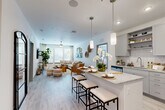 Located at 1050 Beckoning Blvd in Charlotte, NC, this single-story, 2-bedroom, 2-bathroom residence offers a thoughtfully designed open-concept layout. The combined kitchen and living area forms the heart of the home, featuring light hardwood-style flooring, recessed lighting, and a ceiling fan that enhance the bright, airy atmosphere. The kitchen is outfitted with gray shaker-style cabinetry, white subway tile backsplash, stainless steel appliances, and a granite-topped island with bar seating illuminated by modern pendant lights — ideal for both cooking and casual dining. The living area flows seamlessly from the kitchen, with large windows allowing generous natural light. Both bathrooms feature granite countertops, gray cabinetry, and tile flooring; one includes a soaking tub with shower, while the other offers a walk-in shower with floor-to-ceiling tile. Each bedroom is a comfortable retreat — the primary bedroom is generously sized with carpeted floors, a large window, and ample closet space, while the second bedroom maintains a similarly calm, neutral aesthetic. Two dedicated closets and an in-unit laundry area round out the practical offerings of this well-equipped Charlotte residence.