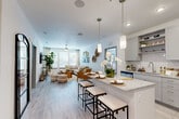 Located at 1050 Beckoning Blvd in Charlotte, NC, this single-story, 2-bedroom, 2-bathroom residence offers a thoughtfully designed open-concept layout. The combined kitchen and living area forms the heart of the home, featuring light hardwood-style flooring, recessed lighting, and a ceiling fan that enhance the bright, airy atmosphere. The kitchen is outfitted with gray shaker-style cabinetry, white subway tile backsplash, stainless steel appliances, and a granite-topped island with bar seating illuminated by modern pendant lights — ideal for both cooking and casual dining. The living area flows seamlessly from the kitchen, with large windows allowing generous natural light. Both bathrooms feature granite countertops, gray cabinetry, and tile flooring; one includes a soaking tub with shower, while the other offers a walk-in shower with floor-to-ceiling tile. Each bedroom is a comfortable retreat — the primary bedroom is generously sized with carpeted floors, a large window, and ample closet space, while the second bedroom maintains a similarly calm, neutral aesthetic. Two dedicated closets and an in-unit laundry area round out the practical offerings of this well-equipped Charlotte residence.