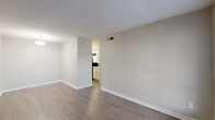 Located at 3719 Country Place Dr in Stafford, TX, this single-story, one-bedroom, one-bathroom unit offers a practical and well-organized layout across its compact footprint. The living and dining areas flow together seamlessly, featuring warm wood-look flooring, neutral gray walls, and clean white baseboards that create a bright, cohesive atmosphere. A large front window allows natural light to fill the living space, enhancing the open feel. The kitchen is efficiently designed with white cabinetry, dark appliances, and easy access from the main living area. A hallway connects the common areas to the private bedroom, which is comfortably sized and finished with plush carpet flooring, a ceiling fan with light fixture, and a window overlooking the exterior. Notably, the bedroom offers an impressive three closets, providing generous storage options rarely found in similarly sized units. The bathroom is clean and functional, featuring a full tub-shower combination, a vanity with a light countertop, and wood-look flooring. A hallway provides additional organizational flow throughout the unit. Overall, the space presents a straightforward, move-in-ready layout with consistent finishes and ample storage throughout.