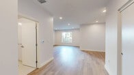 Located at 10375 Washington Blvd in the heart of Culver City, Los Angeles, this modern single-floor unit offers a thoughtfully designed layout across a compact yet efficient footprint. The open-plan kitchen and living area serves as the centerpiece of the space, featuring light hardwood flooring that flows seamlessly throughout. The kitchen is outfitted with high-gloss white upper cabinetry, warm wood-toned lower cabinets, stainless steel appliances including a refrigerator and gas range, a wine cooler, open shelving, and a clean white backsplash — creating a sleek, contemporary aesthetic. Recessed lighting illuminates the entire living area, which is bright and airy thanks to large windows that frame views of lush greenery outside. The bathroom is finished with large-format tile flooring, a frameless glass-enclosed walk-in shower with floor-to-ceiling tile surround, and a vanity with dark stone countertop. A dedicated closet provides practical storage. Crisp white walls, clean lines, and an abundance of natural light give the space a fresh, modern ambiance well-suited to the vibrant Culver City neighborhood.