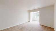 Located at 10150 Torre Ave in Cupertino, California, this single-floor unit offers a clean, functional layout designed for comfortable everyday living. The interior is characterized by neutral white walls, textured ceilings, and plush wall-to-wall carpeting that flows through the main living and sleeping areas, creating a cohesive and understated aesthetic.

The living area is bright and open, benefiting from natural light that streams through a large window fitted with vertical blinds, offering views of the surrounding greenery. An open passageway connects the living space to an adjacent room, enhancing the sense of flow throughout the unit.

The bedroom features a full-width mirrored sliding closet, maximizing storage while adding visual depth to the space. A baseboard heating unit and wall-mounted thermostat provide straightforward climate control.

The kitchen is outfitted with warm honey-toned wood cabinetry, granite-style countertops, a stainless steel sink, and a full-size refrigerator. Tile flooring in the kitchen provides a practical and durable surface. The bathroom, accessible via a hallway, includes tile flooring, a wall-mounted mirror, and grab bar hardware, reflecting a practical and accessible design. Overall, the unit presents a tidy, well-maintained space in the heart of Cupertino.