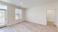 Located at 13300 Ardmore Valley Way in Knoxville, Tennessee, this well-appointed single-story home offers four bedrooms and two bathrooms across a thoughtfully designed floor plan. The open-concept kitchen and living area serves as the heart of the home, showcasing white shaker cabinetry, granite countertops, a subway tile backsplash, and stainless steel appliances including a refrigerator, range, and microwave. A large central island with a undermount sink and pendant lighting above adds both functionality and style. Light wood-style flooring runs throughout the main living areas, creating a clean, cohesive look. The spacious primary bedroom features plush carpeting, a walk-in closet with wire shelving, and direct access to a private bathroom equipped with granite-topped vanity cabinetry. The secondary bedrooms also feature soft carpeting and closets with paneled doors, offering comfortable and practical spaces. Both bathrooms are finished with light wood-style flooring, white cabinetry, and granite countertops. Natural light filters into multiple rooms through windows with horizontal blinds, contributing to a bright and airy atmosphere throughout. The neutral color palette and modern finishes give this home a fresh, move-in-ready appeal.