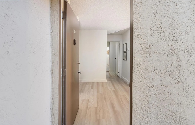 Building Photo - The updated bathroom offers a shower-over-...