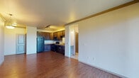 Located on Broken Timber Drive in Monument, Colorado, this single-floor residence offers a thoughtfully laid-out living space with a blend of functional design and comfortable finishes throughout. The open-concept living and dining area is anchored by warm hardwood-style flooring and neutral walls, creating a bright and welcoming atmosphere. A sliding glass door floods the living area with natural light and provides direct access to an outdoor balcony, offering views of the surrounding Colorado landscape. The kitchen is well-equipped with rich dark wood cabinetry, granite-style countertops, and a full suite of black appliances including a refrigerator, electric range, microwave, and dishwasher. Track lighting overhead and ample cabinet storage make this kitchen both practical and visually appealing. A dedicated laundry area with built-in shelving is conveniently accessible from the kitchen. The bedrooms feature plush carpeting, ceiling fans, and windows that allow for natural light, creating comfortable and restful retreats. The bathroom includes a dark wood vanity with a single sink, a large mirror with overhead lighting, tile flooring, and a full soaking tub with a curved shower rod. This well-maintained residence combines everyday practicality with a cozy, residential feel in the desirable Monument, Colorado community.