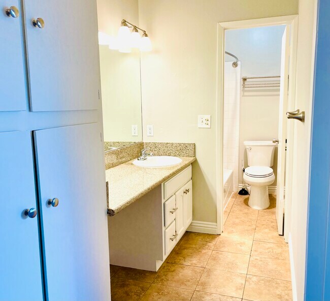 Upstairs full bathroom with granite countertops. - 2416 Curtis Ave
