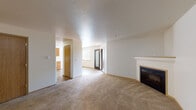 Located at 2948 W Powell Blvd in Gresham, Oregon, this single-floor unit offers a well-organized layout designed for comfortable everyday living. The open living area is finished with plush wall-to-wall carpeting and features a classic fireplace with a white mantle, serving as the room's focal point. A glass-panel entry door allows natural light to filter into the space, enhancing its bright and welcoming ambiance. Textured ceilings are consistent throughout the unit, adding a layer of visual detail overhead.

The kitchen is outfitted with warm honey-toned wood cabinetry providing ample storage, light-colored countertops, and tile flooring. White appliances include an electric range, dishwasher, and refrigerator, all neatly integrated into the L-shaped layout with an overhead range hood.

Multiple carpeted bedrooms each feature windows with views of surrounding greenery, offering a quiet and private feel. The neutral wall tones and soft carpeting create a calm atmosphere throughout.

Two full bathrooms are finished with matching tile flooring and warm wood vanities. Each includes a tub-shower combination and a wide mirror above the single-sink vanity. The consistent design language across both bathrooms contributes to a cohesive interior aesthetic throughout the home.