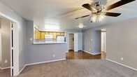 Located at 1088 Park Plaza in Austin, TX, this single-story, 3-bedroom, 2-bathroom home offers a practical and comfortable layout. The open-concept living and dining area features warm neutral tones, plush carpet, and a ceiling fan with light fixture, creating an inviting atmosphere. The kitchen is designed with functionality in mind, showcasing warm wood-toned cabinetry, white appliances including a refrigerator, electric range, and built-in microwave, complemented by light countertops and a peninsula that opens to the living space. Hard-surface flooring runs through the kitchen and dining areas, transitioning to carpet in the living and bedroom spaces. Each of the three bedrooms is fitted with a ceiling fan and carpet flooring; the secondary bedrooms include windows that allow natural light to filter in. The primary bedroom offers a comfortable footprint with convenient closet access. Four closets throughout the home provide generous storage, including a walk-in style closet with built-in shelving and hanging rods. Both bathrooms feature clean white tile surrounds with a tub-shower combination. A connecting hallway links the bedrooms and bathrooms, ensuring an efficient flow throughout the home.