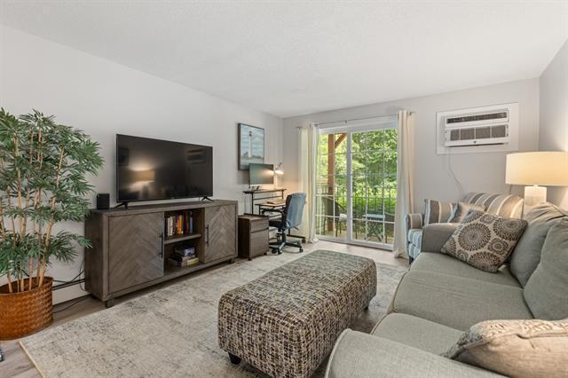 The living room has nice natural light with sliders that open to your private balcony. - 605 White Cedar Blvd