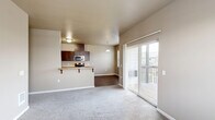 Located at 3517 Hill St SE in Albany, Oregon, this two-bedroom, two-bathroom single-story home offers a practical and comfortable layout. The galley-style kitchen is well-appointed with rich dark wood cabinetry, stainless steel appliances including a refrigerator, electric range, microwave, and dishwasher, complemented by light stone countertops and durable hardwood-style flooring. Adjacent to the kitchen, the dining area features a pendant light fixture and dual windows with blinds that invite natural light and neighborhood views. Both bedrooms are finished with plush carpet and neutral warm-toned walls, each with windows that bring in natural light. The primary bedroom includes access to a spacious walk-in closet outfitted with double hanging rods, offering generous storage. The two bathrooms feature earthy toned tile flooring; one includes a shower stall with a window above, while the other offers a full tub and shower combination with a dark wood vanity. Throughout the home, neutral taupe walls and clean white trim create a consistent, understated aesthetic. The single-floor layout ensures easy accessibility, and the thoughtful room arrangement provides a functional flow throughout the living space.