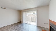 Located at 1111 Railroad Ave in Yuba City, California, this single-floor residence offers a practical and comfortable layout with two bedrooms, three bathrooms, and two closets. The living room features light gray wood-look flooring, built-in wall shelving, and a large sliding glass door dressed with vertical blinds that opens to an outdoor view, flooding the space with natural light. The textured ceiling adds a classic touch throughout the main living areas. The kitchen is well-equipped with rich, warm-toned wood cabinetry extending to the ceiling, light countertops, and white appliances including an electric range, dishwasher, and refrigerator, all set atop light wood-look flooring. The bedrooms are carpeted in neutral tones, offering a soft and cozy feel, with textured ceilings and windows fitted with blinds for privacy. The primary bedroom connects directly to a bathroom, providing added convenience. The bathrooms feature wood-toned vanities with light countertops, mirrors with vanity lighting, and durable wood-look flooring. Throughout the residence, a clean, neutral color palette creates a bright and welcoming ambiance, making this a well-organized and functional home.