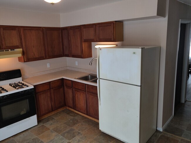 Kitchen offers refrigerator and stove. - 3348 brown st