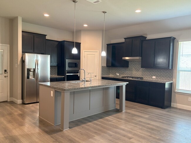 Kitchen with Island and Granite Countertops - 702 Audrey Ln