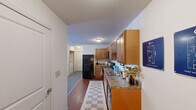 Located at 550 S Windsor Ln in Flagstaff, AZ, this one-bedroom, one-bathroom unit offers a well-organized single-floor layout with a thoughtful arrangement of living spaces. The living room is bright and welcoming, anchored by a large multi-pane window that fills the room with natural light and provides views of the surrounding exterior. Light-toned flooring and neutral walls create a clean, open atmosphere. The kitchen is efficiently designed with warm wood cabinetry, granite-style countertops, and black appliances including an electric range, over-the-range microwave, dishwasher, and full-size refrigerator, all complemented by hardwood-style flooring. The bedroom is a comfortable retreat featuring plush carpeting, a window with sheer curtains that invite soft natural light, and ample space for furnishings. A dedicated closet provides practical storage. The bathroom includes a full tub-shower combination with a curved curtain rod, a single-sink vanity with wood cabinetry, and tile flooring, offering a clean and functional design. Throughout the unit, neutral tones and consistent finishes contribute to a cohesive and comfortable living environment well-suited for Flagstaff's distinctive character.