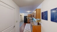Located at 550 S Windsor Ln in Flagstaff, AZ, this one-bedroom, one-bathroom unit offers a well-organized single-floor layout with a thoughtful arrangement of living spaces. The living room is bright and welcoming, anchored by a large multi-pane window that fills the room with natural light and provides views of the surrounding exterior. Light-toned flooring and neutral walls create a clean, open atmosphere. The kitchen is efficiently designed with warm wood cabinetry, granite-style countertops, and black appliances including an electric range, over-the-range microwave, dishwasher, and full-size refrigerator, all complemented by hardwood-style flooring. The bedroom is a comfortable retreat featuring plush carpeting, a window with sheer curtains that invite soft natural light, and ample space for furnishings. A dedicated closet provides practical storage. The bathroom includes a full tub-shower combination with a curved curtain rod, a single-sink vanity with wood cabinetry, and tile flooring, offering a clean and functional design. Throughout the unit, neutral tones and consistent finishes contribute to a cohesive and comfortable living environment well-suited for Flagstaff's distinctive character.