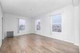 Located at 3333 W 4th St in the heart of Los Angeles, this 1-bedroom, 1-bathroom unit offers a well-organized, single-floor layout with a clean, modern aesthetic throughout. Light wood-tone flooring runs continuously across all rooms, complementing the crisp white walls and trim that give the space a bright, airy feel.

The living room is generously sized and bathed in natural light from multiple large windows, offering elevated views of the surrounding Los Angeles cityscape. An arched doorway connects the living area to the hallway, adding a subtle architectural charm. The bedroom is a comfortable size, featuring two dedicated closets for ample storage and windows that frame neighborhood rooftop views.

The galley-style kitchen is efficiently laid out with white shaker cabinetry, dark countertops, a double stainless steel sink, a gas range, and a refrigerator — all complemented by recessed lighting and a window that brings in additional natural light.

The bathroom features wood-look flooring, a full soaking tub, and elegant marble-style tile surround that extends to the ceiling, alongside a white vanity and a frosted window for natural light and privacy.

A hallway connects all rooms seamlessly, and includes a built-in arched niche that adds a classic architectural detail. The overall ambiance is clean, neutral, and move-in ready.