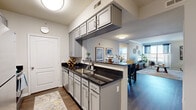 Located at 612-628 N New Ballas Rd in Creve Coeur, Missouri, this well-designed single-floor residence offers a thoughtfully planned layout that balances comfort and modern style. The kitchen is a functional highlight, featuring gray shaker-style cabinetry, dark granite countertops, stainless steel appliances including a range and over-the-range microwave, a subway tile backsplash, and a peninsula with an integrated sink that opens to the dining and living areas. Rich hardwood-style flooring runs throughout the main living spaces, adding warmth and continuity. The dining area comfortably accommodates a full-sized table and is positioned adjacent to the kitchen for seamless entertaining. The living room is generously proportioned, with crown molding, large windows that invite abundant natural light, and views to the outside. The primary bedroom offers plush carpeting, a ceiling fan, a double-door closet, and a bright window with exterior views. The secondary bedroom is equally comfortable, with carpeted flooring, a ceiling fan, and natural light from a well-sized window. The bathroom includes a combination tub and shower, a dark granite vanity countertop, and hardwood-style flooring. Overall, the space presents a clean, contemporary aesthetic with cohesive finishes throughout.