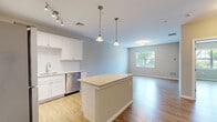Located at 731 Federal Rd in Brookfield, CT, this well-appointed one-bedroom, one-bathroom residence offers a thoughtfully designed single-floor layout. Light-toned hardwood-style flooring runs throughout, complementing the neutral wall palette and creating a clean, cohesive aesthetic.

The open-concept kitchen is a standout feature, showcasing crisp white shaker cabinetry, a classic subway tile backsplash, and granite countertops. A central island provides additional prep and seating space, while pendant lighting adds a polished touch overhead. Stainless steel appliances — including a gas range, built-in microwave, refrigerator, and dishwasher — complete this functional and stylish kitchen.

The kitchen flows seamlessly into the living area, which benefits from natural light through a street-facing window. The generously sized bedroom also features a window with an outdoor view and direct access to a walk-in closet equipped with multi-tier wire shelving for ample storage.

The bathroom is finished with a dark-stained wood vanity topped with a white countertop, a large mirror, and a full soaking tub with a shower combo. Track and pendant lighting throughout enhance the overall brightness of the residence, making it a practical and inviting living space.