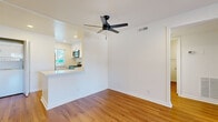 Located at 22833 Vanowen St in the West Hills neighborhood of Los Angeles, this 3-bedroom, 2-bathroom single-floor unit offers a clean, updated interior with a cohesive modern design throughout. Warm hardwood-style flooring runs continuously across all living areas, lending a sense of continuity and brightness to the space.

The living room is an open, airy area anchored by a sleek ceiling fan and flows directly into the kitchen via a pass-through counter. The kitchen is well-appointed with white shaker cabinetry, marble-look quartz countertops, stainless steel appliances including a gas range and built-in microwave, and a modern faucet — making it both functional and visually appealing.

The three bedrooms are bright and simply finished, each featuring neutral walls, hardwood-style flooring, and natural light through windowed blinds. The primary bedroom includes a sliding glass door that opens to a private outdoor patio with garden views, offering a peaceful retreat. The remaining bedrooms feature textured ceilings and windows with exterior views.

The two bathrooms are clean and functional, each featuring white vanities with under-cabinet storage and shower-tub combos with glass enclosures and chrome or brushed nickel fixtures. A hallway connects the bedrooms and bathrooms, keeping the layout practical and well-organized.