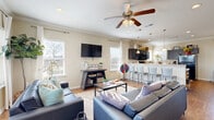 Located in Murfreesboro, Tennessee, this two-story home offers a thoughtfully designed layout spread across two floors. The main floor features an open-concept living area where the living room flows seamlessly into the kitchen and dining space. The living room is bright and welcoming, with multiple windows, crown molding, hardwood-style flooring, and a ceiling fan overhead. The kitchen is well-equipped with dark cabinetry, a classic subway tile backsplash, black appliances, and a breakfast bar with seating — ideal for casual dining or entertaining. The upper floor houses the bedrooms, each featuring plush carpeting, ceiling fans, and natural light from neighborhood-facing windows. The generously sized primary bedroom provides a comfortable retreat, while the additional bedrooms offer ample space for furnishings and storage. Five bathrooms throughout the home ensure convenience for all occupants. A dedicated laundry room with a full-size washer and dryer adds everyday practicality. Two staircases connect the floors, enhancing circulation throughout the home. With a warm, neutral color palette, crown molding accents, and functional spaces on every level, this home delivers a comfortable and versatile living experience.