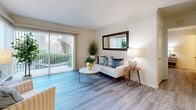 Located at 5600 Orangethorpe Ave in La Palma, California, this one-bedroom, one-bathroom residence offers a thoughtfully designed single-floor layout that maximizes comfort and functionality. Light wood-style flooring flows consistently throughout every room, lending a cohesive and airy feel to the entire space.

The living room is a welcoming retreat, highlighted by a large sliding glass door that invites abundant natural light and provides views of the outdoor greenery beyond. The adjoining dining area features a ceiling fan and a generous window dressed with vertical blinds, creating a bright and comfortable setting for everyday meals.

The kitchen is efficiently designed with white cabinetry, granite-toned countertops, and full appliances, offering everything needed for home cooking in a clean, well-organized space.

The spacious bedroom accommodates a full-sized bed with ease and includes a dedicated closet, a wall-mounted mirror, and a window that allows natural light to filter through. The neutral palette and wood-look floors contribute to a calm, restful ambiance.

The bathroom is neatly appointed with a sliding glass shower-tub enclosure, a vanity with white cabinetry and gold hardware, and light, neutral wall tones that maintain the residence's clean aesthetic throughout.